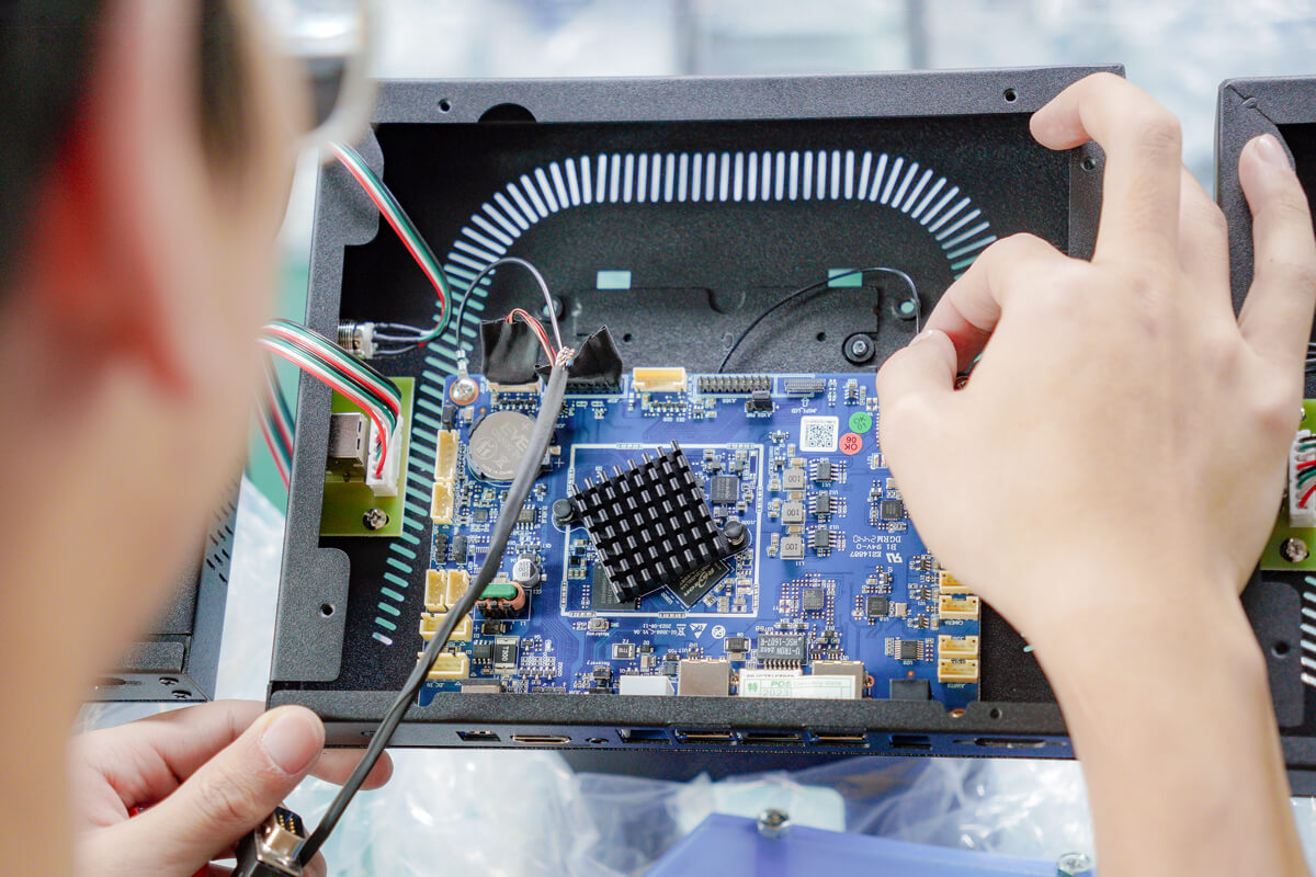 Pos System factory workers are installing pos hardware