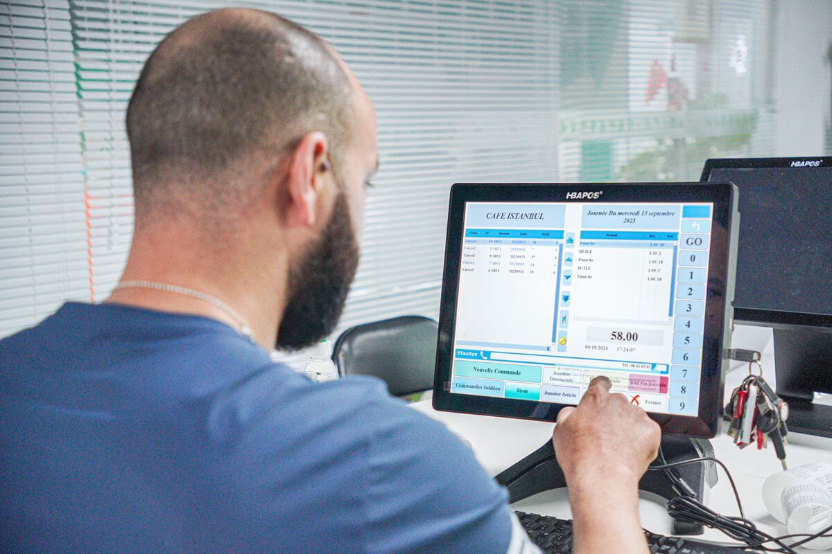 An engineer is teaching his staff how to install a pos system